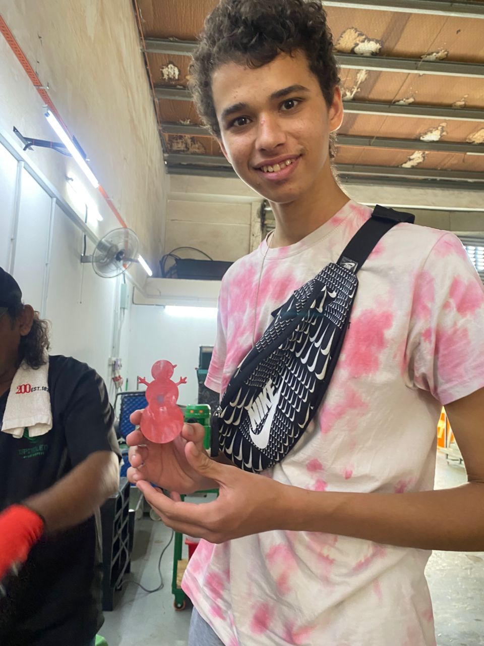 Student holding an upcycled plastic workshop item